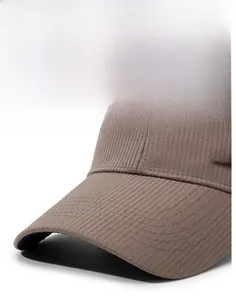 Detailed macro view of coffee-colored breathable sport cap with metal label and stitching