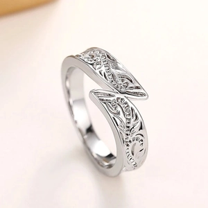 Retro silver bypass ring featuring intricate embossed vine patterns and polished finish