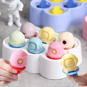 Detail view of astronaut-shaped silicone popsicle sticks and colorful frozen treats