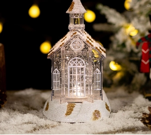 Detailed view of crystal church music box with sparkling glitter and festive warm lighting