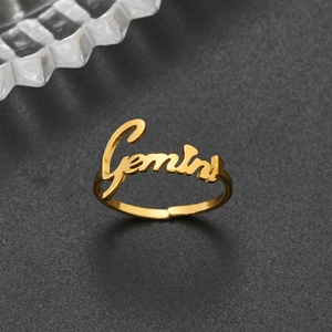 Macro detail of adjustable golden 18K stainless steel ring with Gemini cursive font