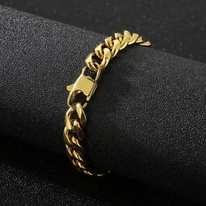 Macro detail of 11mm gold polished titanium steel Cuban link bracelet on a black display