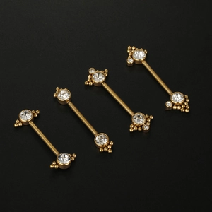 Golden nipple rings with sparkling zircon spheres on a black matte background