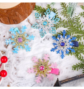 Detailed view of rhinestone snowflake hair clips in pastel colors with winter holiday decor