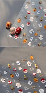 Details von 3D-Präge-Weihnachtsnagelstickern mit Schneeflocken und süßen Cartoon-Motiven