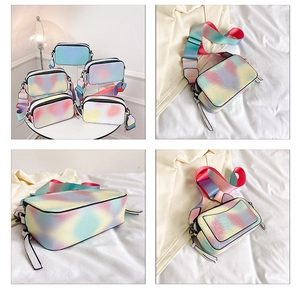 Detailed views of a rainbow gradient camera bag with wide strap and pebble texture