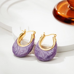 Detail view of U-shaped gold earrings with elegant purple marble enamel finish