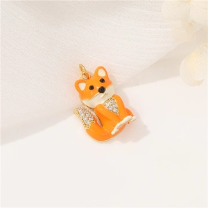 Cute orange fox pendant with enamel finish and sparkling zircons on white fabric
