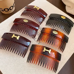 Retro acrylic tortoiseshell hair comb set with golden H logo and oval metal accents