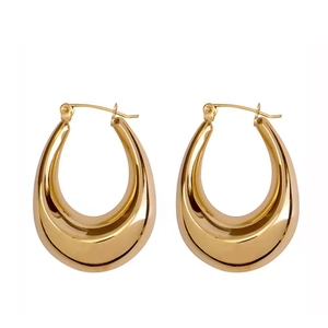 Macro detail of thick hollow oval earrings in 18K gold plated stainless steel