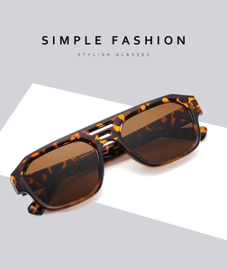 Detail view of tortoiseshell polygon sunglasses with stylish double bridge on a white base