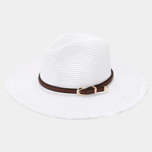 Detail view of woven straw sun hat featuring a fringed edge and brown leather belt buckle