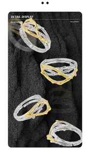 Detail view of two-tone irregular winding vine S925 silver ring on black background