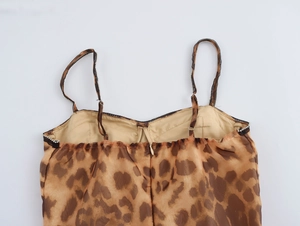 Detailed back view of leopard print mini dress featuring rhinestone trim and hidden zipper