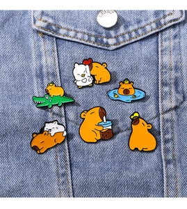 Detail of cute enamel capybara pins pinned on blue denim jacket pocket as trendy accessories