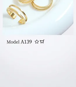 Top view of gold double-row parallel line adjustable open rings in white bowl