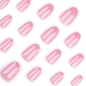 Classic pink french press on nails with white tips and silver glitter stripes on white backdrop