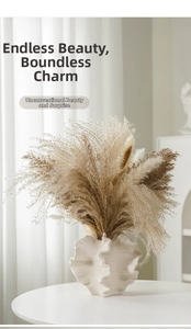 Detail showing the matte texture of the white ceramic vase with dried pampas grass decor