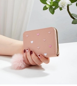 Detailed close-up of a pink mini card purse with embroidered hearts and zipper closure