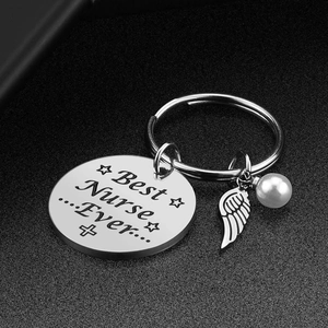 Silver stainless steel Best Nurse Ever keychain with angel wing and pearl charm on dark background