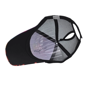 Detail view of the black ponytail baseball cap's breathable mesh and interior wash label