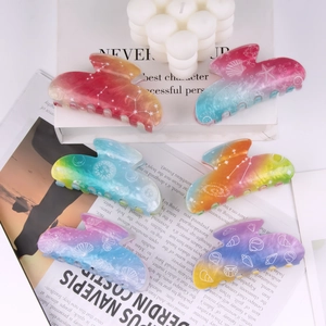 Rainbow gradient shell and starfish hair claws 6-piece set displayed on white decor