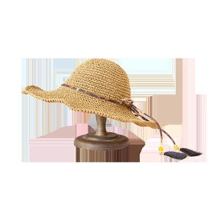 Khaki straw sun hat with large brim featuring leopard print ribbon and black tassels