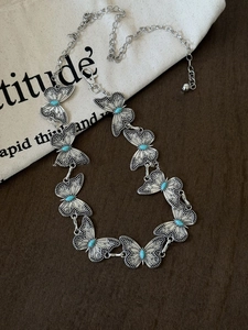 Detailed macro of bohemian silver butterfly waist chain with turquoise gemstone inlays
