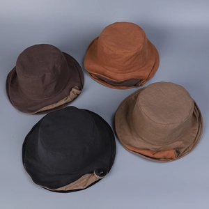 Detail of vintage linen sun hats with double-layered brims in multiple earthy colors