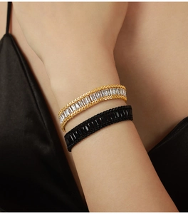 Detail of titanium steel bracelets with rectangular zircons and woven texture edges