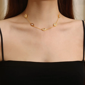 18K gold plated necklace with evil eye pendants and transparent stones on a female model