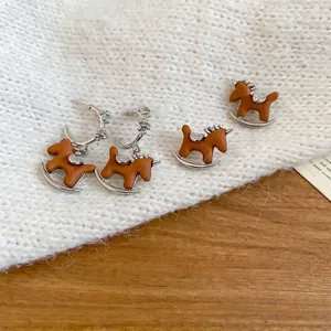 Set orecchini a forma di cavallo a dondolo in resina marrone con perni d'argento