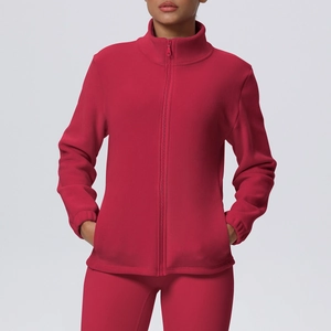 Detail of the high collar and textured fleece fabric on a red zip-up sports jacket
