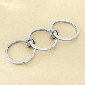 Close-up of polished multi-layered silver stainless steel rings with interlocking detail