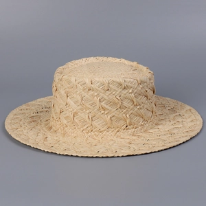 Top view of natural raffia flat top boater hat with detailed hand-woven texture
