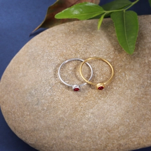 Minimalist gold and silver stainless steel rings with red birthstones on stones