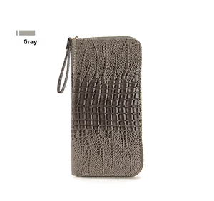 Vista detallada de la cartera larga gris con relieve de cocodrilo y correa de muñeca