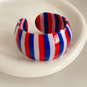 Wide open cuff bracelet with red, white, and blue vertical stripes in glossy resin finish
