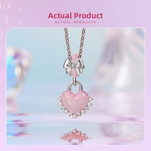 Close-up of pink heart locket pendant with silver bow and pearl accents on fine chain