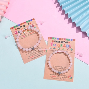 Pink zebra stone bracelet with heart charm and back to school gift card on pastel background