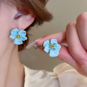 Elegant 3D blue flower earrings with yellow rhinestone center in a stylish pair