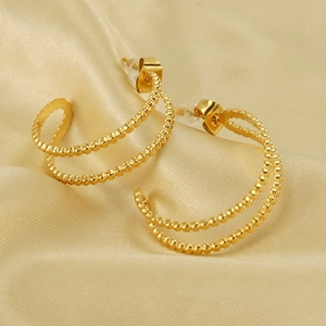 18K gold plated geometric beaded hoop earrings on elegant light gold silk fabric background
