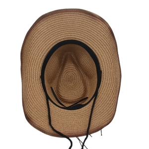 Detailed inner view of brown straw cowboy hat with black sweatband and windproof rope