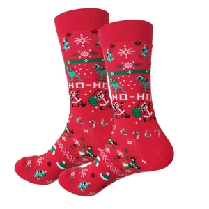 Close-up of red Christmas socks featuring Santa, dinosaurs, and festive patterns