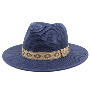 Detail view of the navy blue straw fedora with ethnic geometric embroidery band