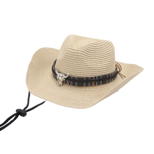 Detail of woven straw hat with ethnic band, metal bull head and adjustable chin strap
