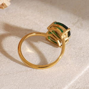Detailed macro view of the gold prong setting and square green zircon on a stainless steel ring