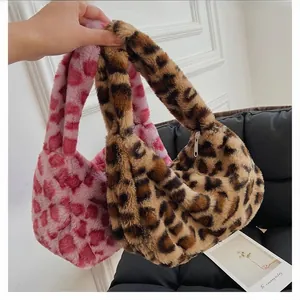 Detail shot of fluffy faux fur handbags in leopard print and pink heart patterns