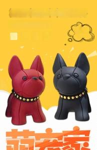 Detail of red and black resin French Bulldog keychains with gold studded collars