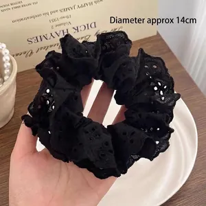 Large black lace scrunchie with hollow floral pattern measuring 14cm in diameter